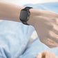 Black leather and carbon-fiber watch strap worn on a wrist