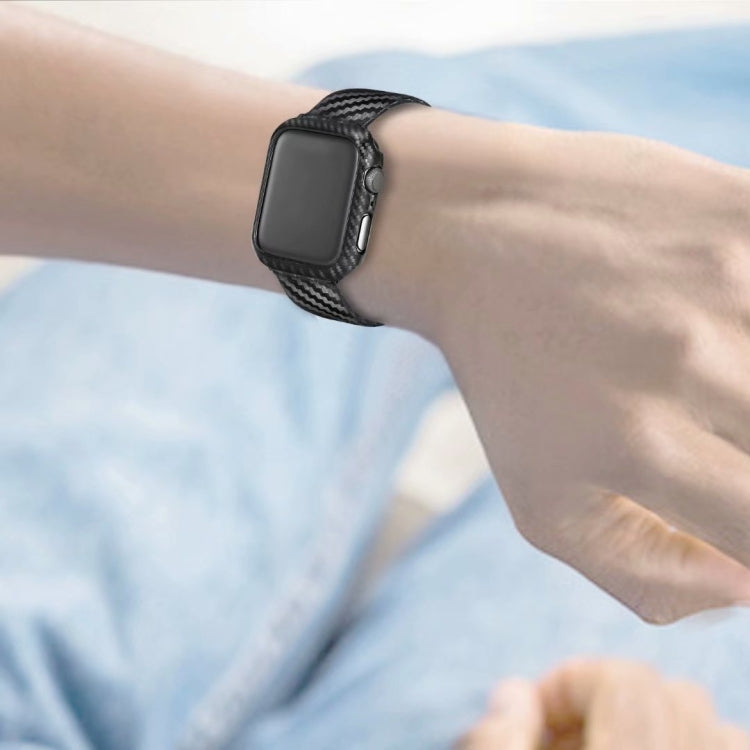 Black leather and carbon-fiber watch strap worn on a wrist