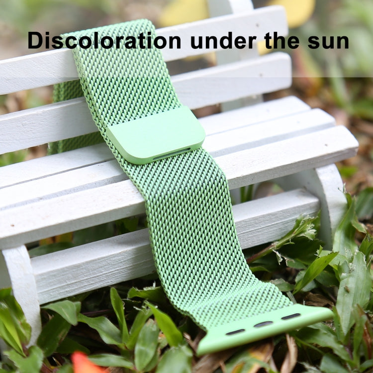 Green woven nylon magnetic watch band resting outdoors with end pin slots