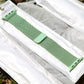 Green woven nylon watch band with magnetic clasp and perforated side slots