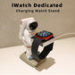 Astronaut watch stand holding an Apple Watch on a black charging cradle