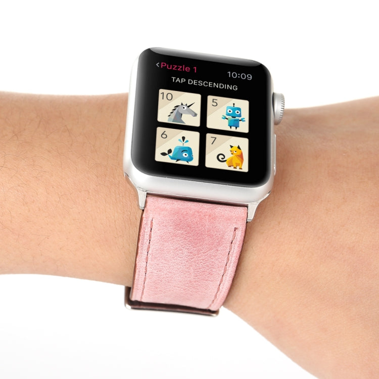 Genuine leather Apple Watch band on wrist, pink strap and silver buckle clasp detail