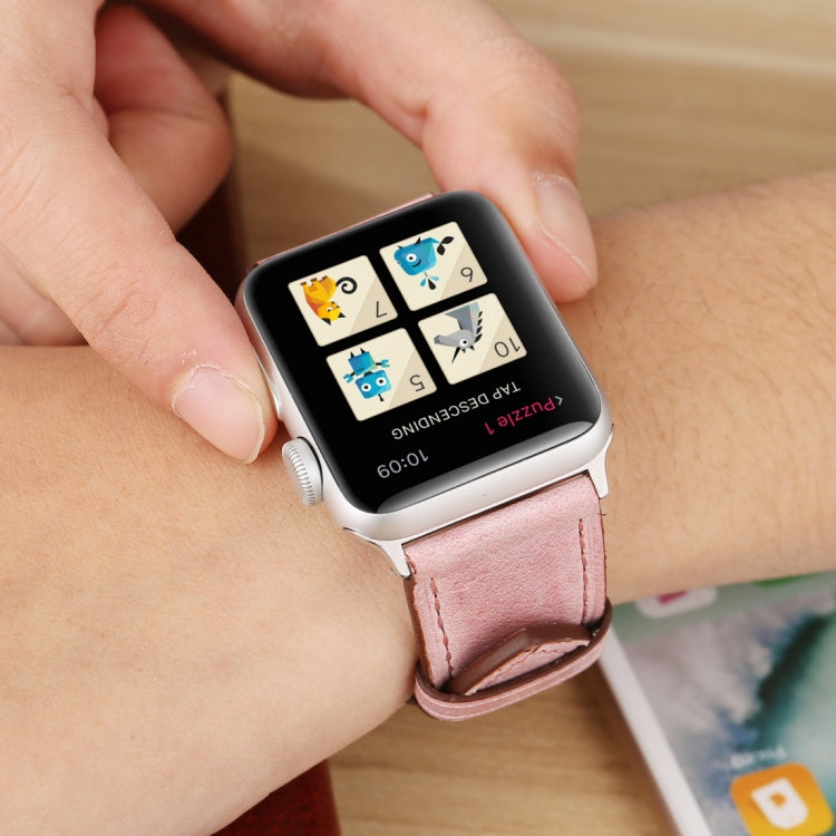 Genuine leather Apple Watch band on wrist, pink leather strap with stitched edge and buckle