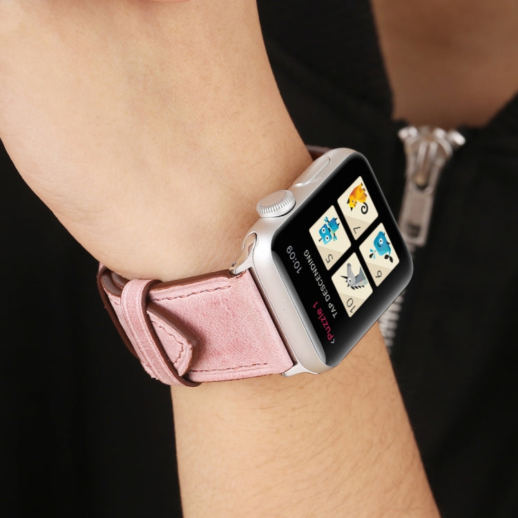 Genuine leather Apple Watch band on wrist, pink strap with brown lining and silver buckle
