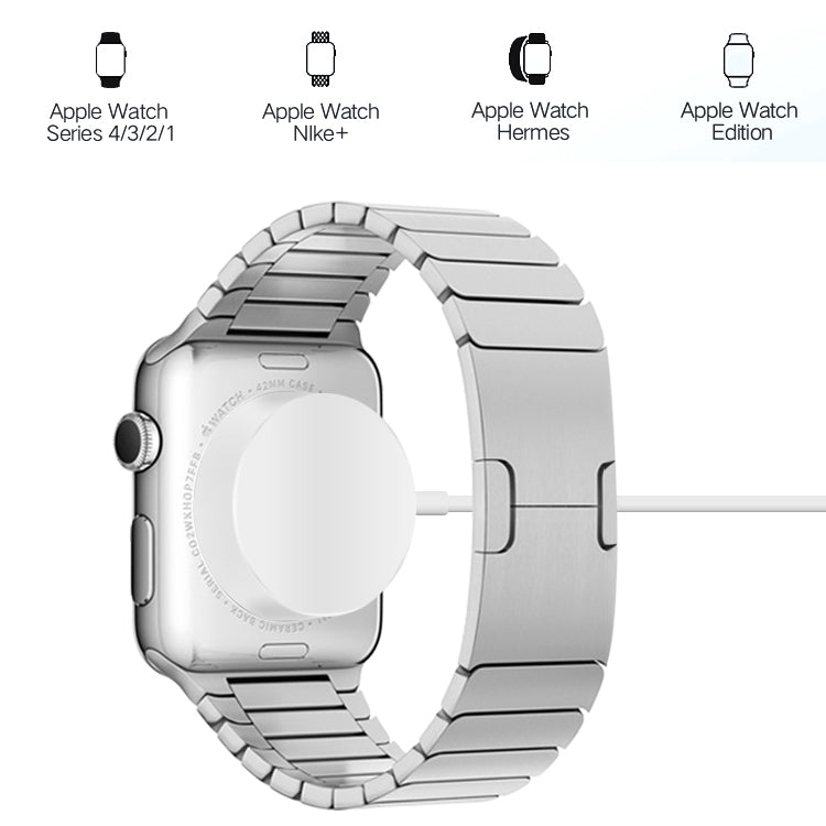 Magnetic charging cable connected to a silver smartwatch on a charging dock.