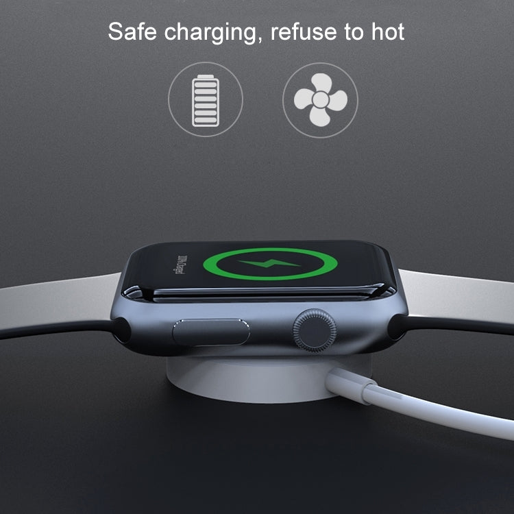 Magnetic charging puck attached to a smartwatch with USB cable for active charging.