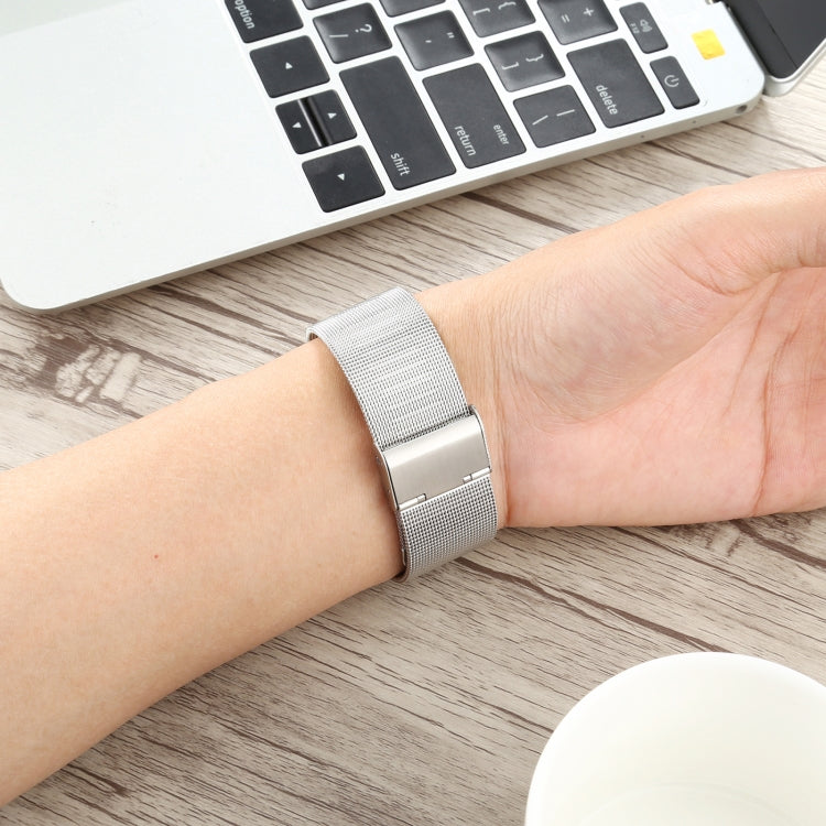Silver mesh stainless steel watch band on wrist for Apple Watch 38mm, fold-over clasp