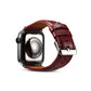 Apple Watch with dark red crocodile-grain leather band, side profile with buckle