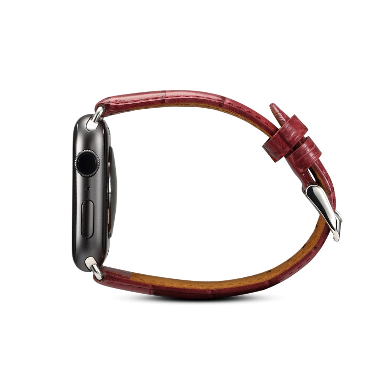 Dark red crocodile-grain leather watch band with metal clasp, viewed from side