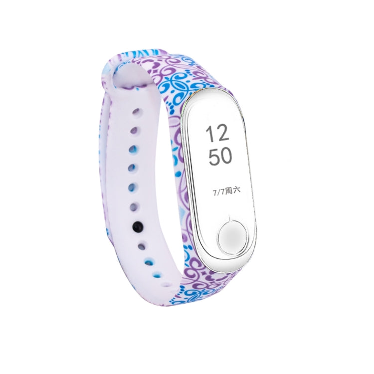 Silicone watch band with blue floral swirl pattern, white perforated strap, fitness tracker display