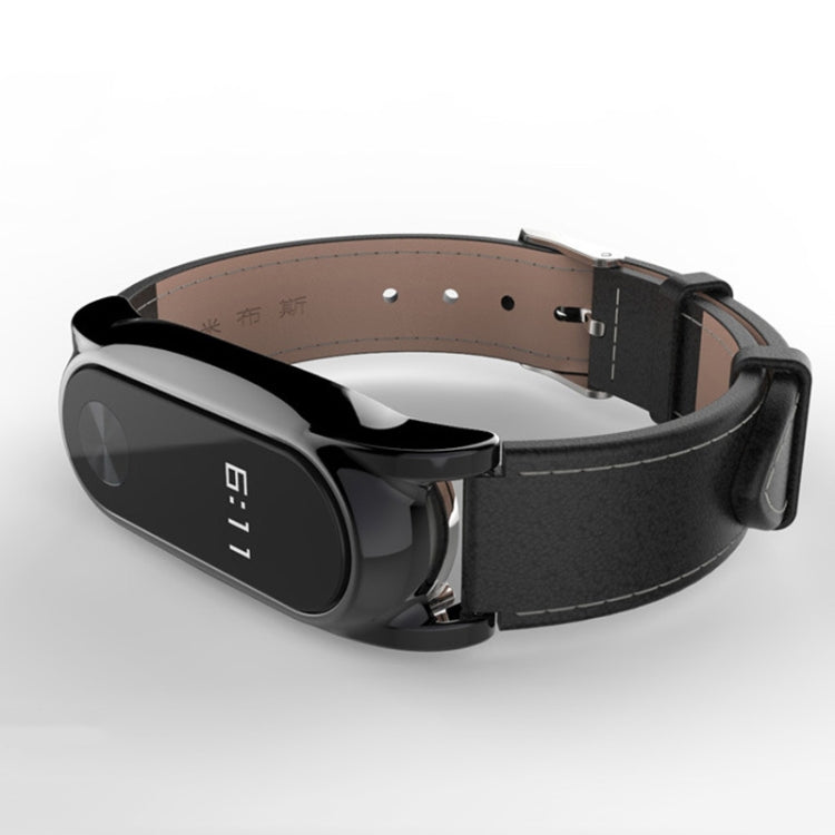 Screwless magnetic watch band with black case and dark strap with tan inner backing