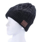 Black textured knit Bluetooth beanie hat on head form with brown control patch