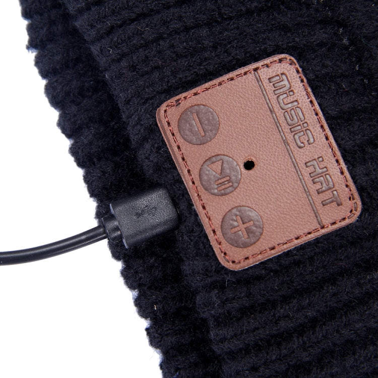 Bluetooth beanie control patch close-up with buttons and attached headset cable