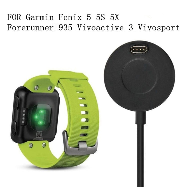 Desktop charging dock shown with green smartwatch band and charging connector