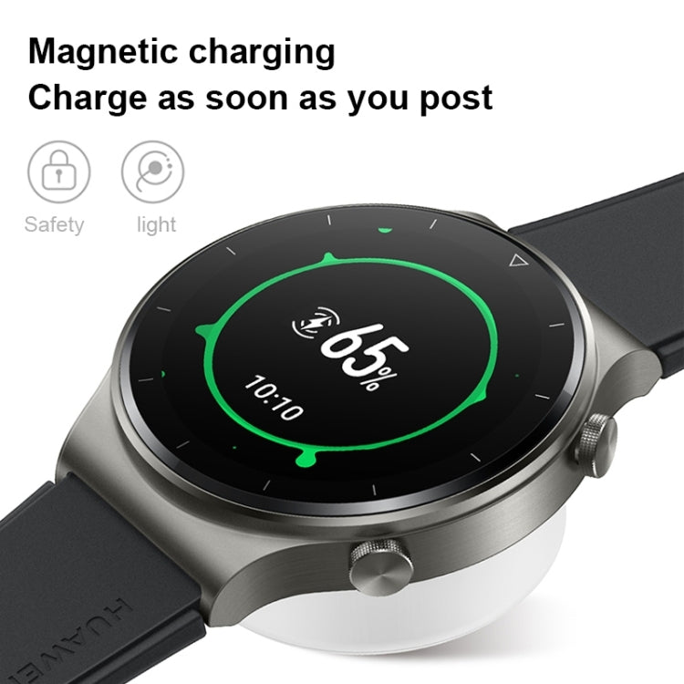 Magnetic wireless smartwatch on charging base with green progress indicator