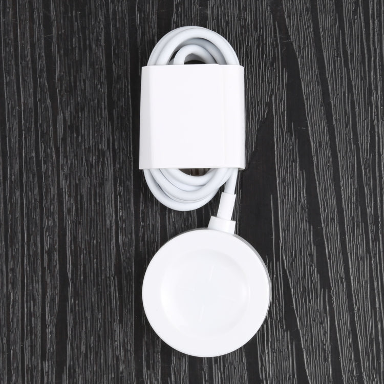 White round magnetic charging dock with attached cable and connector