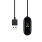 Black USB charging cable with USB-A plug and oval charging dock with contact pins