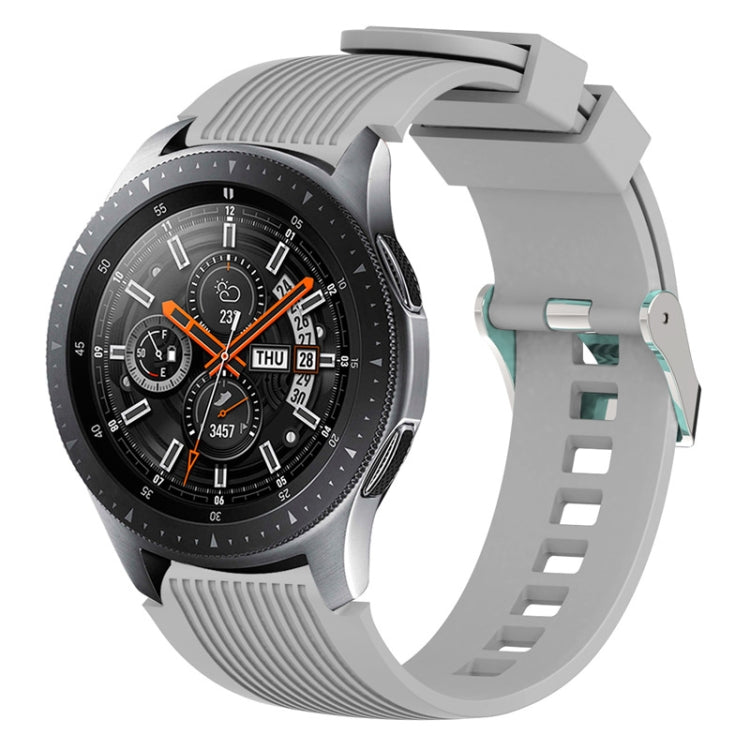 Grey silicone watch band with vertical grain ridges and adjustable buckle holes