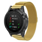 Gold milanese watch band with clasp on a round smartwatch