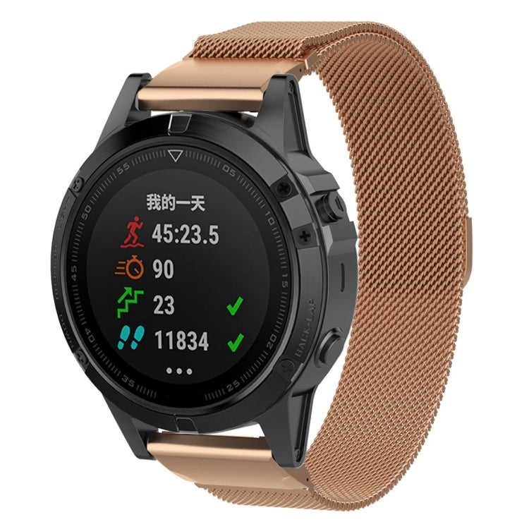 Rose gold milanese watch band with clasp, worn on a round smartwatch