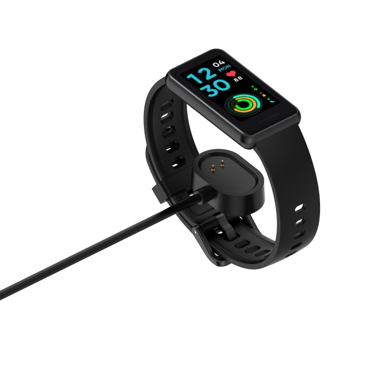 Magnetic charging cable with round dock connected to a smart band, black.