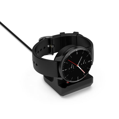 Black silicone smartwatch charging bracket with cradle and cable, holding a watch.