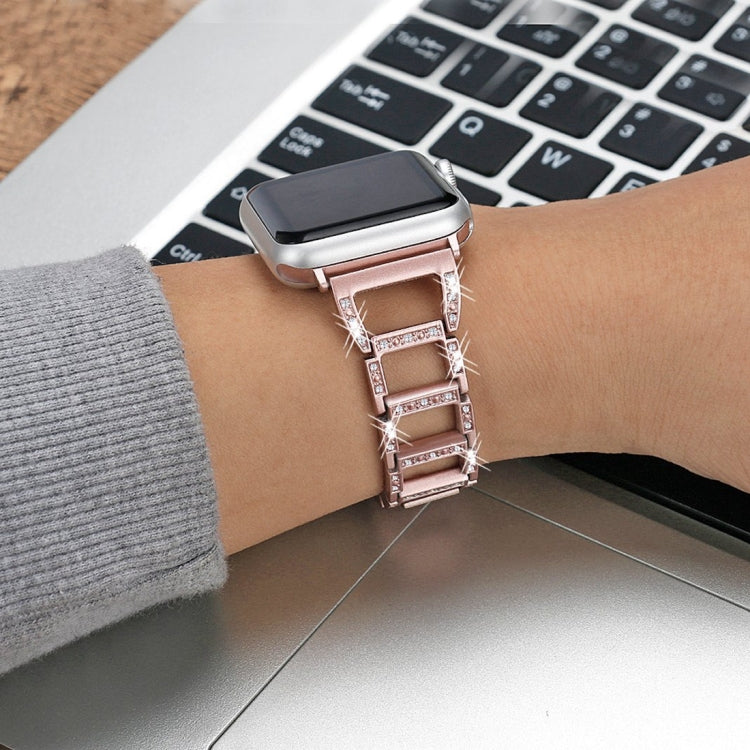 Rose gold diamond watch band on wrist with smartwatch case and metal clasp