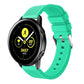 Mint green silicone smartwatch band with perforated strap and metal buckle hardware