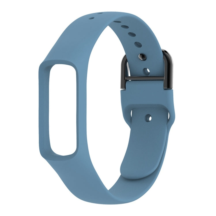Light blue silicone watch band with metal clasp and adjustment holes, angled side view.