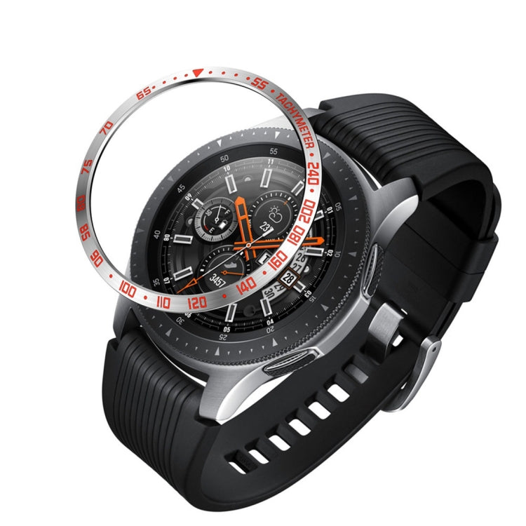 Black steel protective watch frame with silver outer ring, red markers, and orange dial