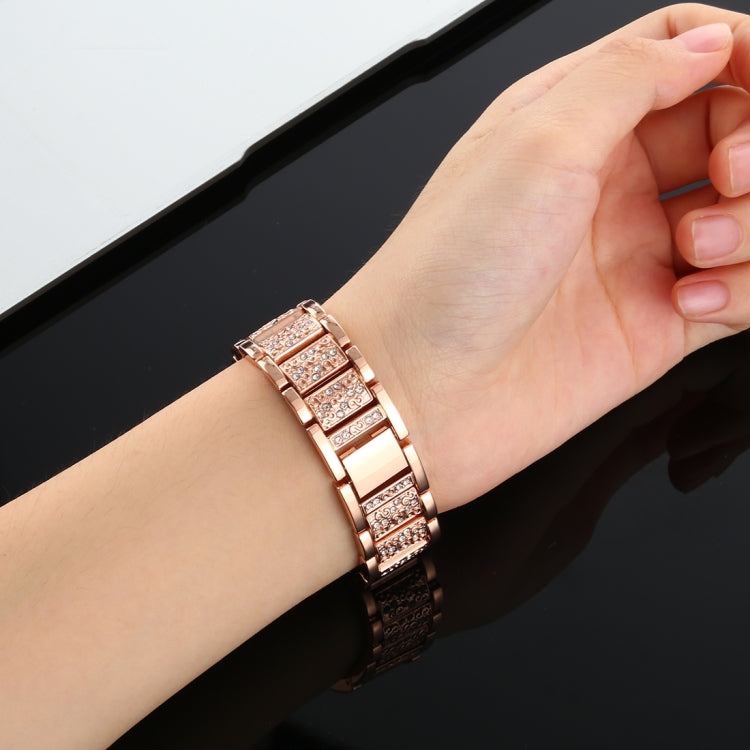 Rose gold diamond-studded stainless steel watch band on wrist with secure clasp