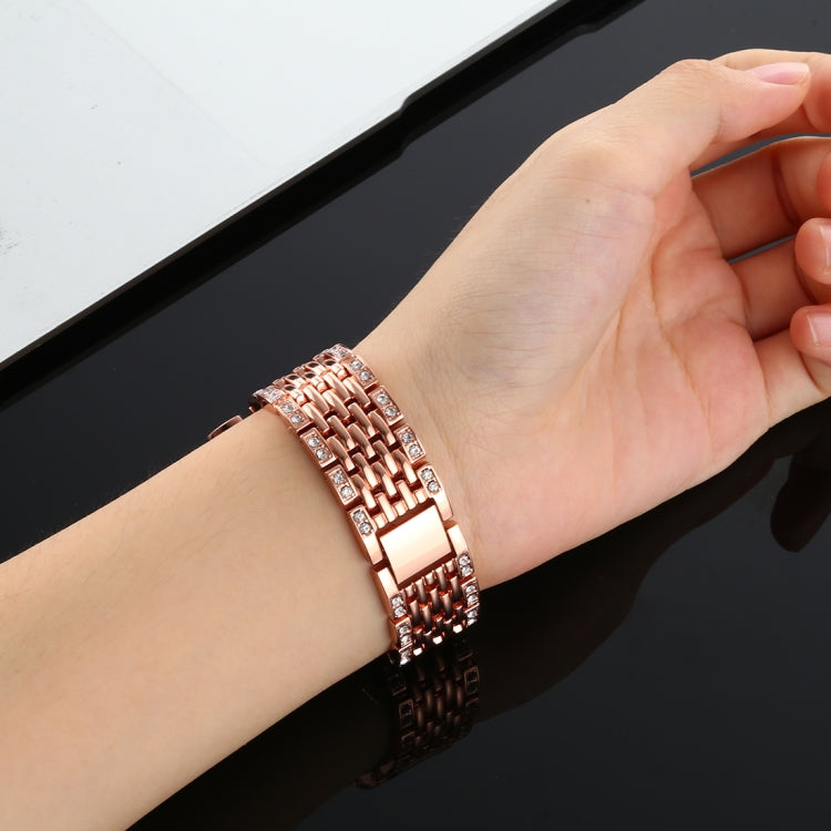 Rose gold diamond-studded watch band on wrist, multi-row links with stones