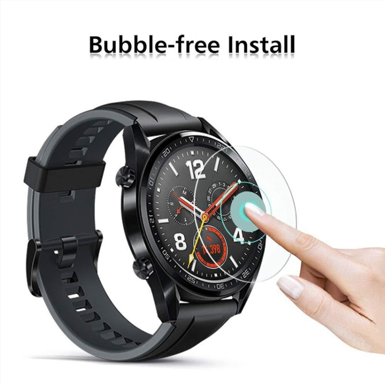 Tempered glass screen protector film being applied to round smartwatch display