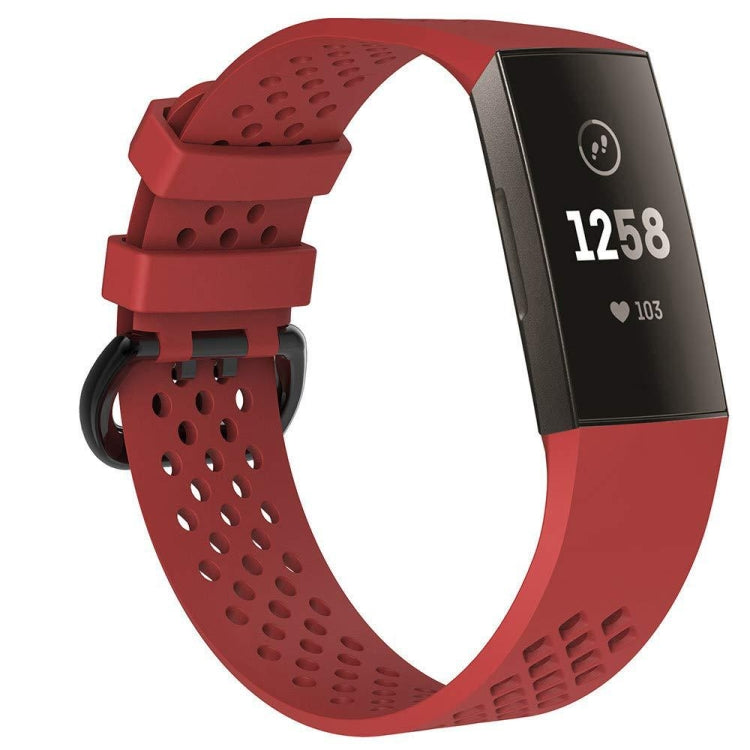 Red perforated sport watch band with adjustable strap and textured clasp area.