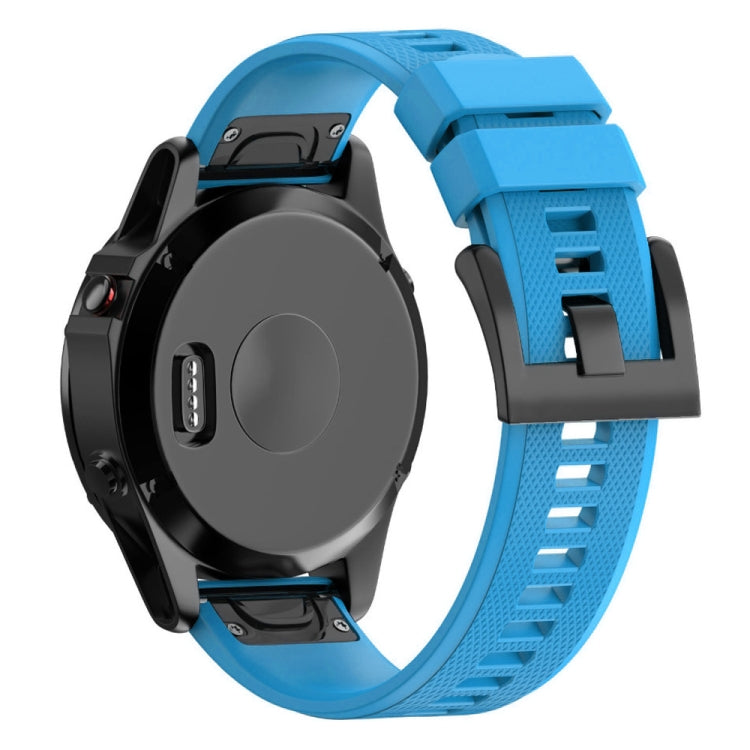 Blue silicone watch band with textured surface and quick-release attachment