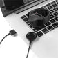 Charging puck and cable plugged into laptop USB port for smart watch