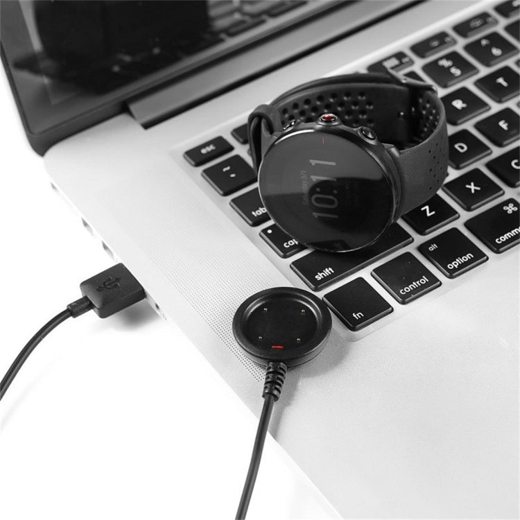 Charging puck and cable plugged into laptop USB port for smart watch