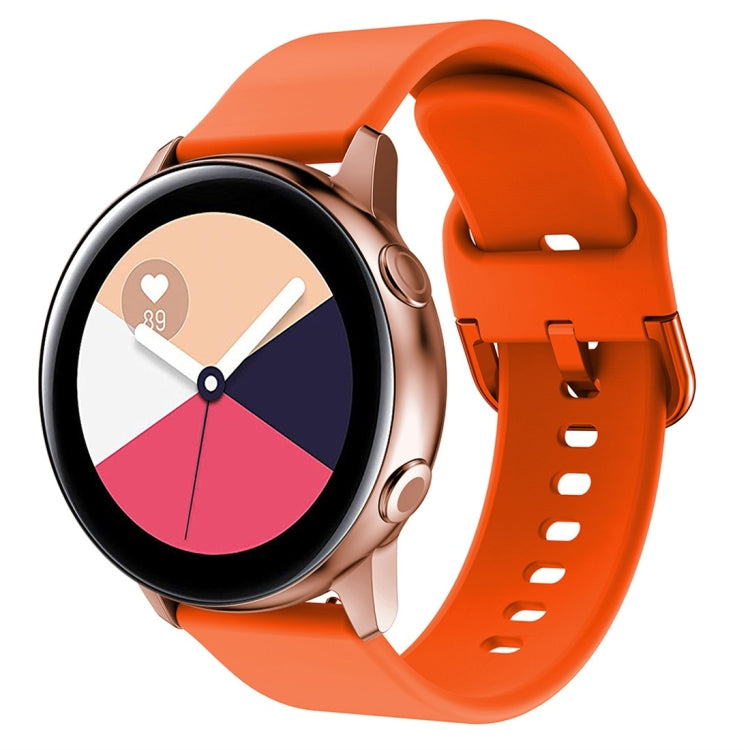 Orange silicone watch band with metal buckle and perforated holes for smartwatch