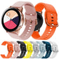 Pink and orange silicone watch bands with metal buckles, plus multiple color bands