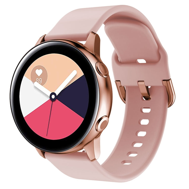 Pink silicone watch band with metal buckle and perforated strap holes