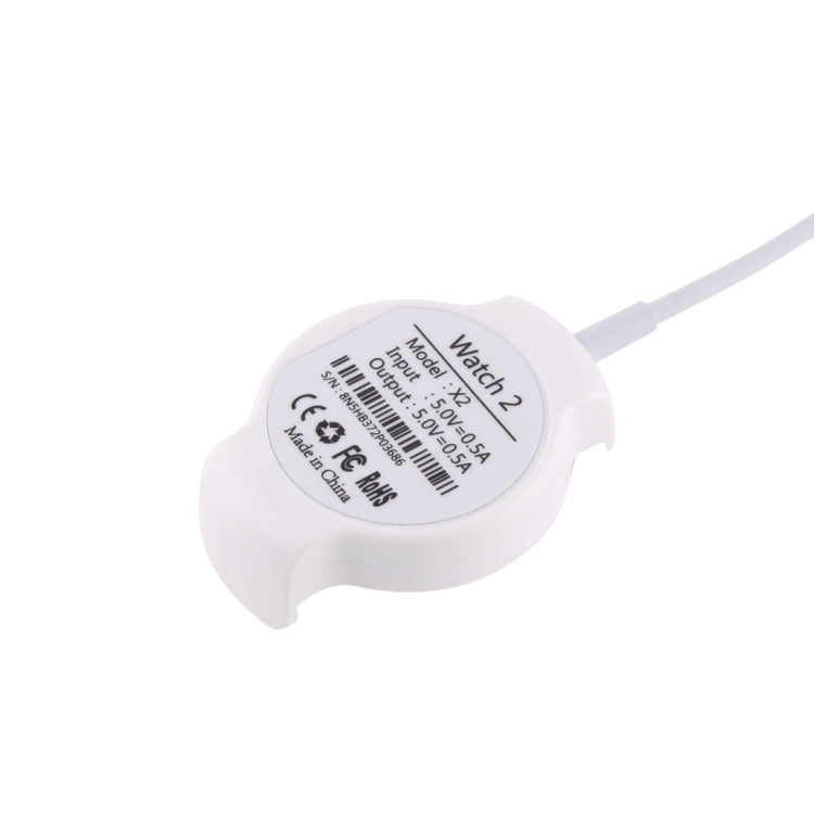 White watch charging cradle showing model label and USB charging cable