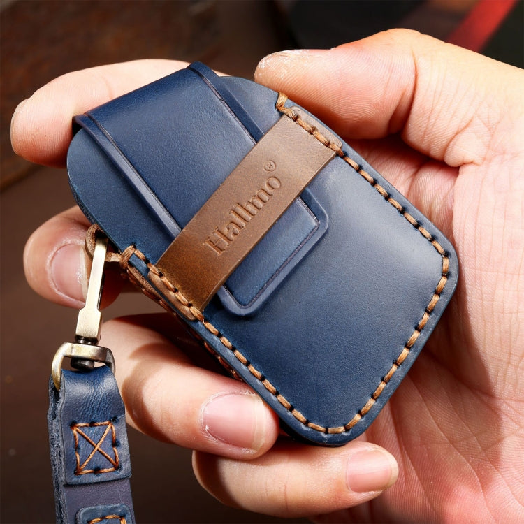 Blue leather 5-button car key case held in hand with keyring and stitched border