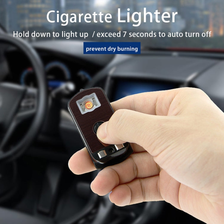 Red cigarette lighter with solar panel and small ignition button, held in hand