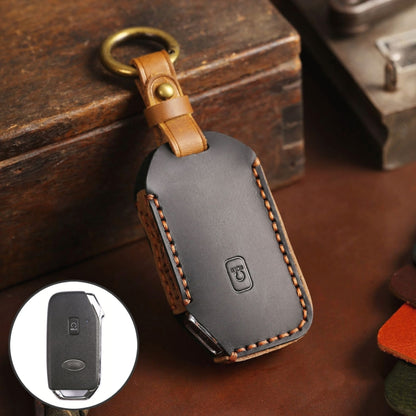 Leather key protective case with gray finish, brown stitching and metal key ring loop