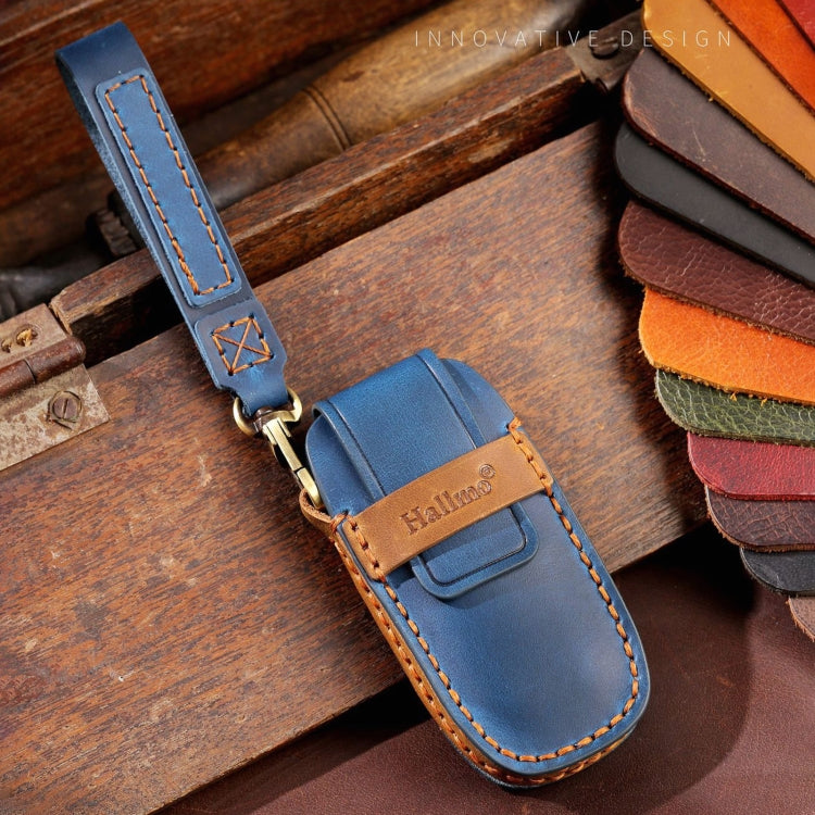 Blue leather key fob cover with tan logo patch and key ring loop