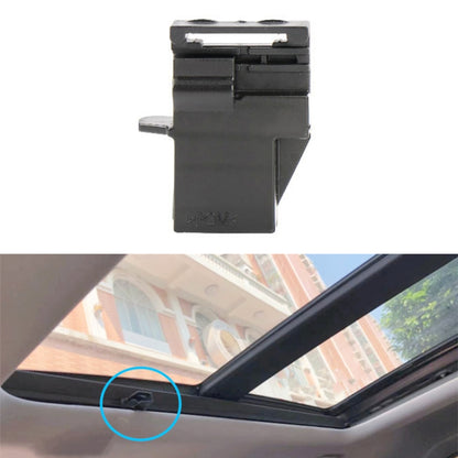 Dark plastic sunroof sunshade buckle latch near roof console