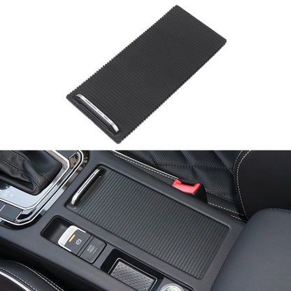 Black textured central armrest box cover with chrome-edged pull slot