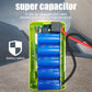 Open green jump starter housing with blue supercapacitor cells and red cable leads