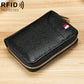 Black textured multi-card wallet with top zipper, gold-tone trim and flag emblem.