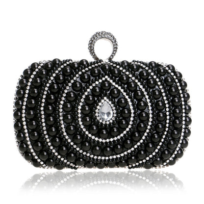Black beaded pearl swirl clutch handbag with teardrop rhinestone center and ring handle